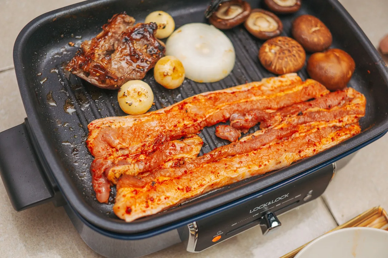 Korean barbecue pork belly grilling at the table