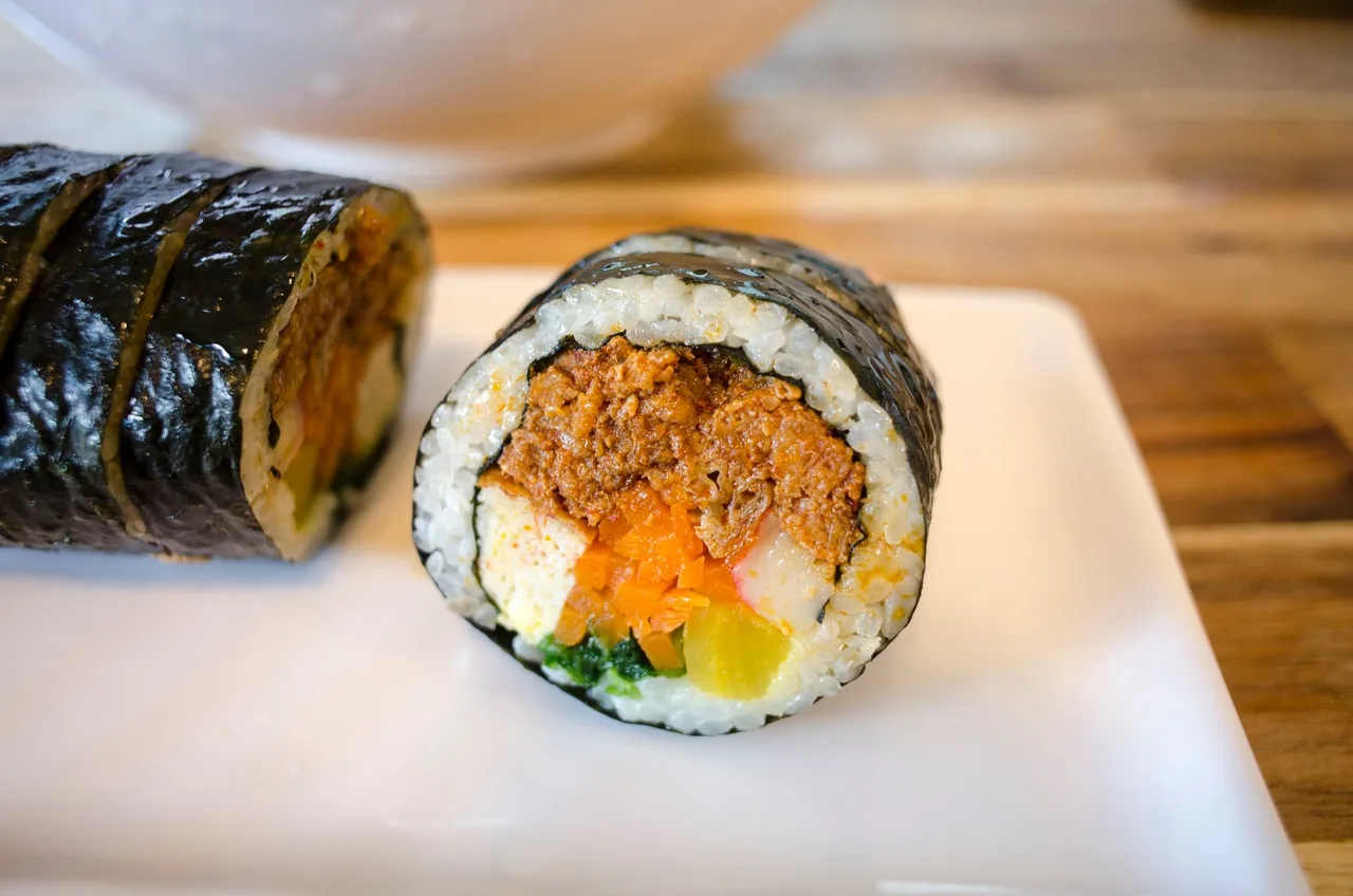 Rolls of vegetable gimbap sliced on a plate