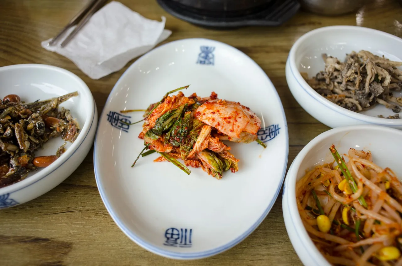 A Korean set meal spread of small vegetable dishes and rice